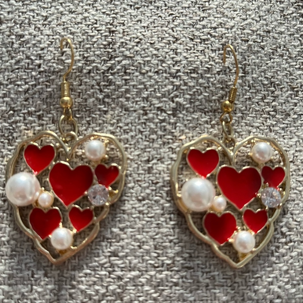 Beautiful Heart shape Pearl with red enamel rhinestone setting.